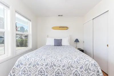 a white bedroom with a bed and a window at Charming 3Br Beach Home W Rooftop Deck One Block From Sand By Beachview Rentals in Newport Beach