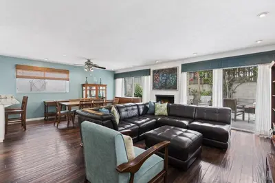 a living room with a couch and a table at Affordable 3Br Near Beach, Walk To Shops, Dining And More By Beachview Rentals in Newport Beach