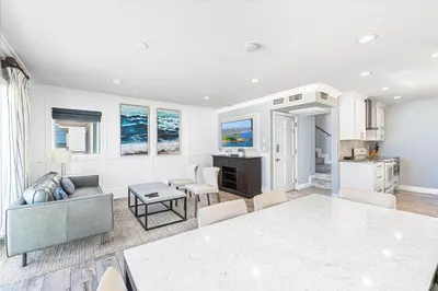 a living room with a couch and a table at Modern 3Br Oceanfront W Rooftop Deck And Panoramic Views By Beachview Rentals in Newport Beach