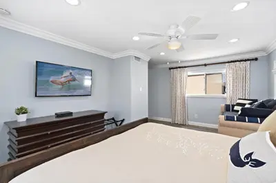 a living room with a bed and a couch at Modern 3Br Oceanfront W Rooftop Deck And Panoramic Views By Beachview Rentals in Newport Beach
