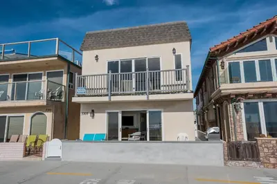 a house with a balcony on top of it at Modern 3Br Oceanfront W Rooftop Deck And Panoramic Views By Beachview Rentals in Newport Beach
