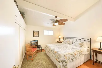 a bedroom with a bed and a ceiling fan at Spacious 6Br W Oceanview And Garden Patio, Steps To Sand By Beachview Rentals in Newport Beach