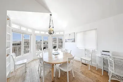 a white dining room with a table and chairs at Spacious 6Br W Oceanview And Garden Patio, Steps To Sand By Beachview Rentals in Newport Beach