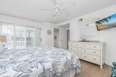 a bedroom with a bed and a dresser and a window at 7Br Duplex W Oceanview Balcony And Ac, Walk To It All By Beachview Rentals in Newport Beach