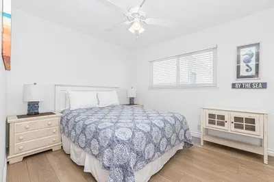 a bedroom with a bed and a ceiling fan at 7Br Duplex W Oceanview Balcony And Ac, Walk To It All By Beachview Rentals in Newport Beach