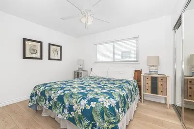 a white bedroom with a bed and a window at 7Br Duplex W Oceanview Balcony And Ac, Walk To It All By Beachview Rentals in Newport Beach
