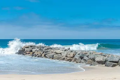 a group of waves crashing on a beach at Remodeled 2Br Oceanfront W Spacious Patio, Stunning Views By Beachview Rentals in Newport Beach