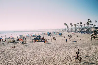 a large group of people on a beach at Steps To Sand! 7Br Retreat W Ocean Views In Prime Location By Beachview Rentals in Newport Beach