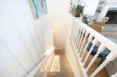 a staircase in a home with white railings at 2Br Beach Escape W Oceanview Deck, 2 Houses From The Sand By Beachview Rentals in Newport Beach