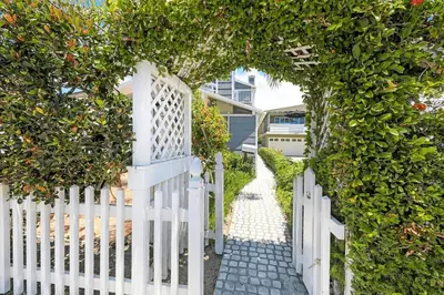 a white picket fence with a white gate at 2Br Beach Escape W Oceanview Deck, 2 Houses From The Sand By Beachview Rentals in Newport Beach