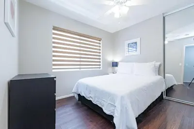 a white bedroom with a bed and a window at 3Br Oceanfront At Balboa Pier, Ac, Walk To It All By Beachview Rentals in Newport Beach