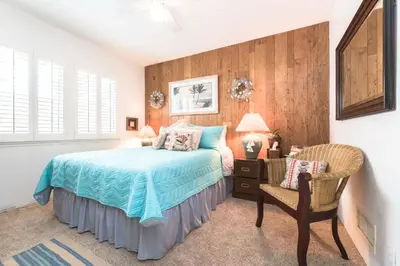 a bedroom with a bed and a chair at Spacious 3Br Bayfront W Harbor Views, Walk To Beach By Beachview Rentals in Newport Beach