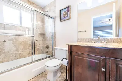 a bathroom with a shower toilet and a sink at 3Br Oceanfront At Balboa Pier W Ac And Great Walkability By Beachview Rentals in Newport Beach