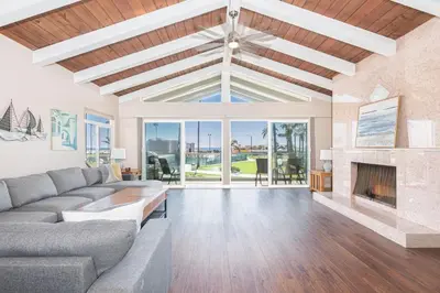 a living room with a couch and a fireplace at 3Br Oceanfront At Balboa Pier W Ac And Great Walkability By Beachview Rentals in Newport Beach