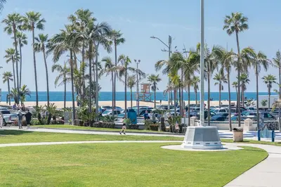 a park with palm trees and the beach at 3Br Oceanfront At Balboa Pier W Ac And Great Walkability By Beachview Rentals in Newport Beach