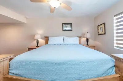 a bedroom with a blue bed with two night stands at 3Br Oceanfront At Balboa Pier W Ac And Great Walkability By Beachview Rentals in Newport Beach