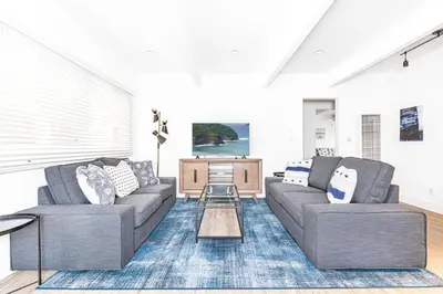 a living room with two couches and a table at Luxury 6Br Triplex In Prime Location One House From Sand By Beachview Rentals in Newport Beach