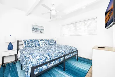 a bedroom with a bed and a ceiling fan at Luxury 6Br Triplex In Prime Location One House From Sand By Beachview Rentals in Newport Beach