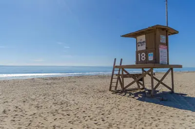 a lifeguard stand on a beach with the ocean at Charming 3Br W Large Deck, Walk To Beach And Marina Park By Beachview Rentals in Newport Beach