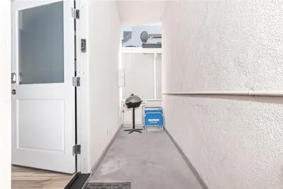 an empty hallway with an open door and a trash can at 8Br Coastal Getaway W Gorgeous Views At An Excellent Value By Beachview Rentals in Newport Beach