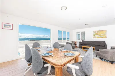 a dining room with a table and chairs at Renovated 3Br Oceanfront W Panoramic Views By Beachview Rentals in Newport Beach
