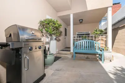 a grill and a blue bench on a patio at Quiet 1Br Bayside Apartment, Central, Steps To Baybeach By Beachview Rentals in Newport Beach