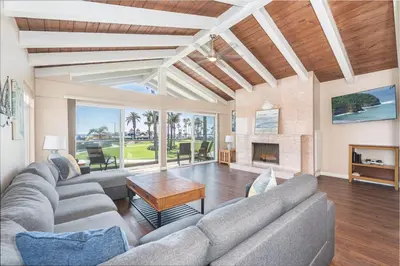 a living room with a couch and a fireplace at 6Br Oceanfront Duplex, Ac, Steps To Beach And Balboa Pier By Beachview Rentals in Newport Beach