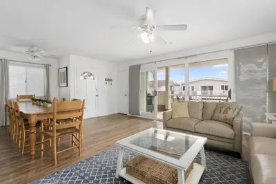 a living room with a couch and a table at Epic 7Br Retreat W Oceanview Rooftop Deck - Steps To Sand By Beachview Rentals in Newport Beach