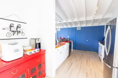 a kitchen with blue walls and a red counter top at The Lantern House, Walk to Harbor, Great Outdoors in Dana Point