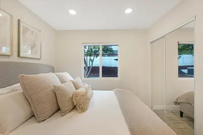 a white bedroom with a bed and a window at Neat Retreat w Hot Tub Near Beach and Downtown in San Diego
