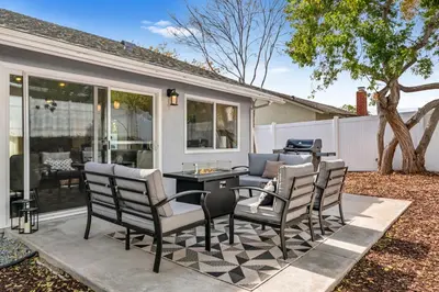 a patio with chairs and a table and a couch at Neat Retreat w Hot Tub Near Beach and Downtown in San Diego
