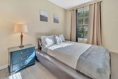 a bedroom with a bed with a blue dresser and a window at Heart of Carmel Valley 2BR, Families and Corp Stays in San Diego