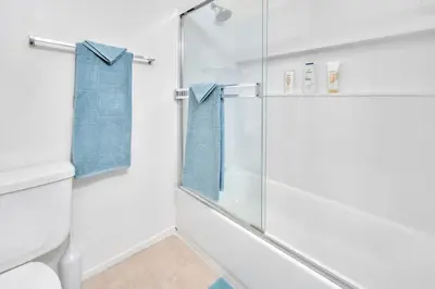 a bathroom with a glass shower stall and a toilet at Heart of Carmel Valley 2BR, Families and Corp Stays in San Diego