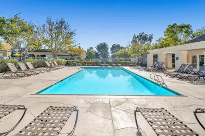 a swimming pool with chaise lounge chairs and a pool at Heart of Carmel Valley 2BR, Families and Corp Stays in San Diego