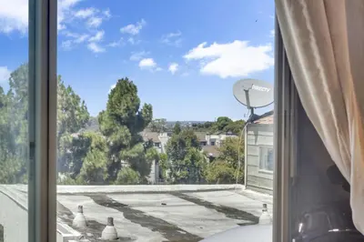a window with a view of a roof at Point Loma 2BR Townhome w Parking in Prime Location in San Diego