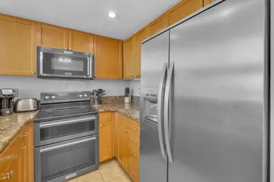 a kitchen with a stainless steel refrigerator and a microwave at Point Loma 2BR Townhome w Parking in Prime Location in San Diego