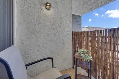 a balcony with a chair and a wooden fence at Point Loma 2BR Townhome w Parking in Prime Location in San Diego