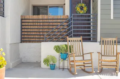 two chairs and a potted plant on a porch at Point Loma 2BR Townhome w Parking in Prime Location in San Diego