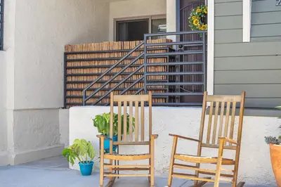 two chairs sitting on the porch of a house at Point Loma 2BR Townhome w Parking in Prime Location in San Diego