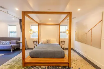 a bedroom with a canopy bed in a room at Deluxe Master Studio Private Entrance and Patio in San Diego
