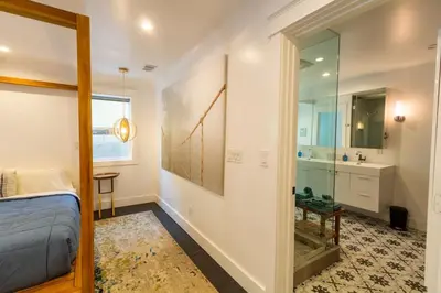 a bedroom with a bed and a sink and a mirror at Deluxe Master Studio Private Entrance and Patio in San Diego