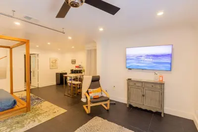 a room with a bed and a desk and a television at Deluxe Master Studio Private Entrance and Patio in San Diego