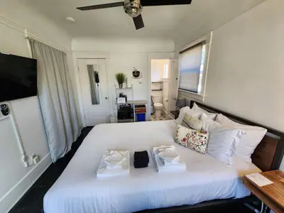 a bedroom with a large white bed with two pillows at Studio w Private Entrance Convenient and Cozy in San Diego
