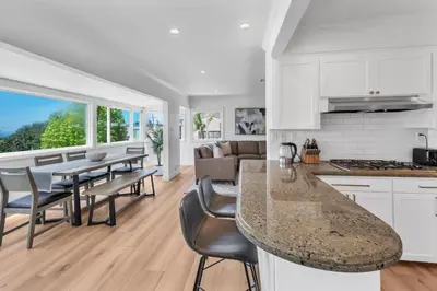 a kitchen and dining room with a table and chairs at Stunning 3BR Capo Beach Home with Ocean Views in Dana Point