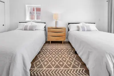 two beds sitting next to each other in a bedroom at Stunning 3BR Capo Beach Home with Ocean Views in Dana Point