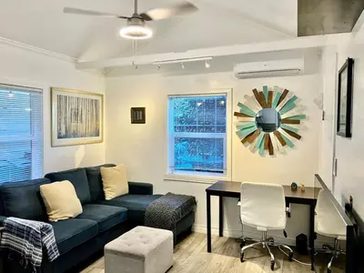 a living room with a blue couch and a table at North Park 1BR Cottage Prime Location with Parking in San Diego