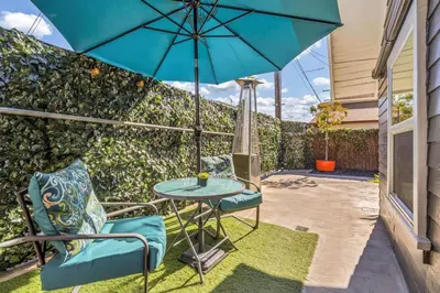 a patio with a table and two chairs and an umbrella at North Park 1BR Cottage Prime Location with Parking in San Diego