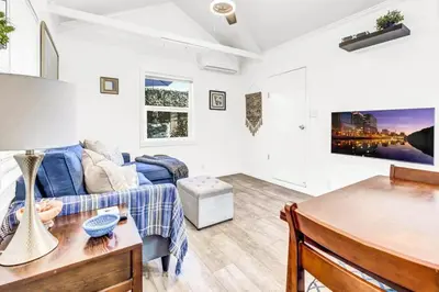 a living room with a blue couch and a table at North Park 1BR Cottage Prime Location with Parking in San Diego
