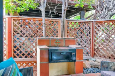 a wooden fence with a stove in a yard at Old Town 1BR Short Drive to Downtown and Beaches 4.5 in San Diego