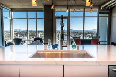 a large conference room with a large table with windows at Modern Downtown SD Apartment Stunning City Views in San Diego